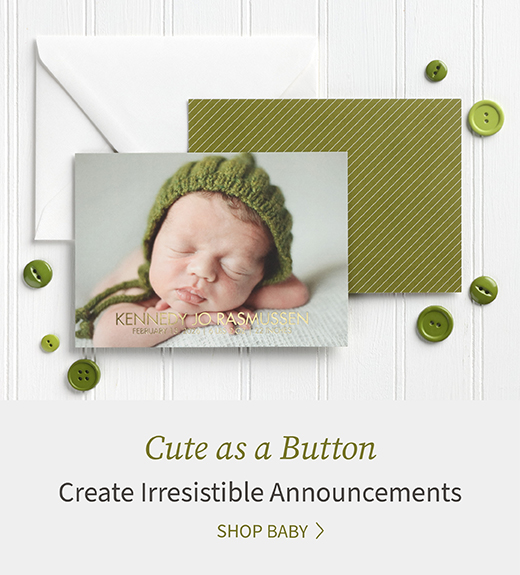 A newborn baby photo is featured on the front of a photo announcement with green back and button accents.