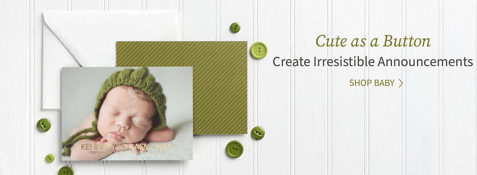 A newborn baby photo is featured on the front of a photo announcement with green back and button accents.