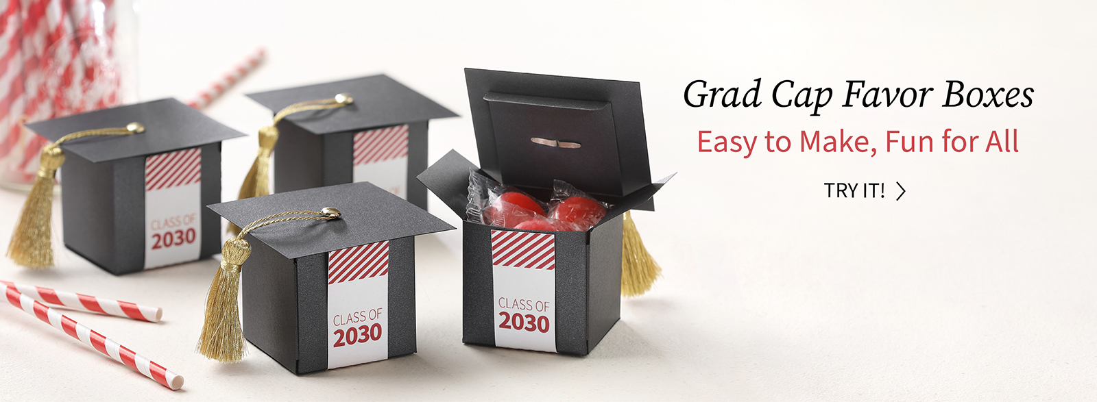 Black favor boxes are turned into grad caps and finished with red and white labels.